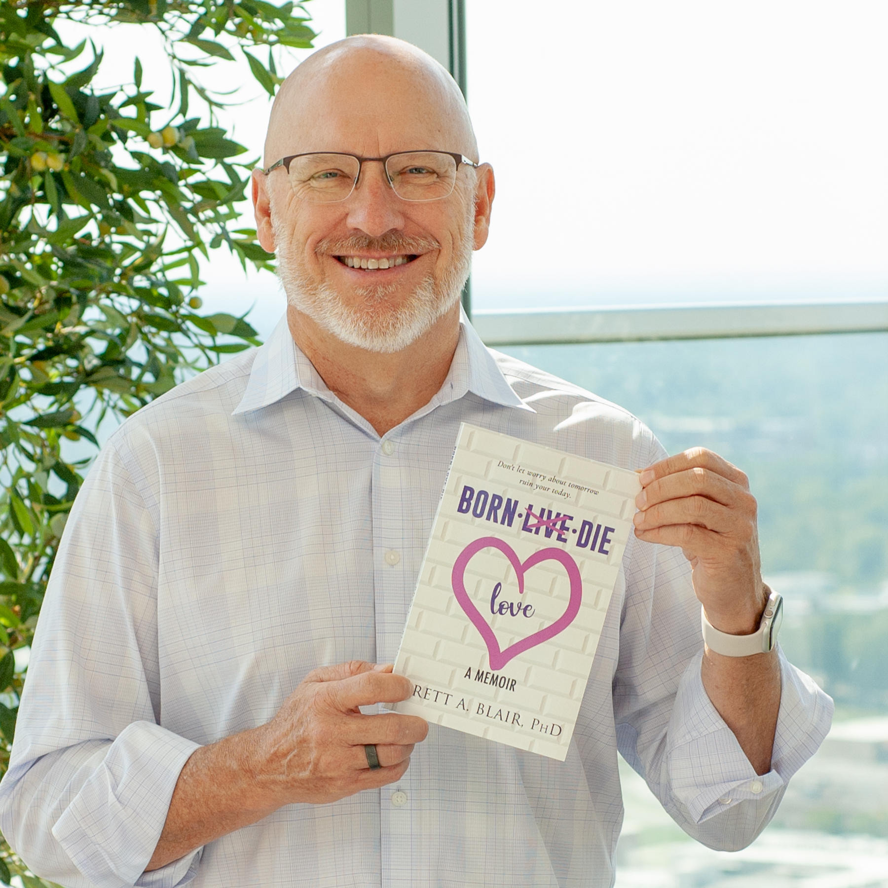 Dr. Brett Blair holding Born Love Die
